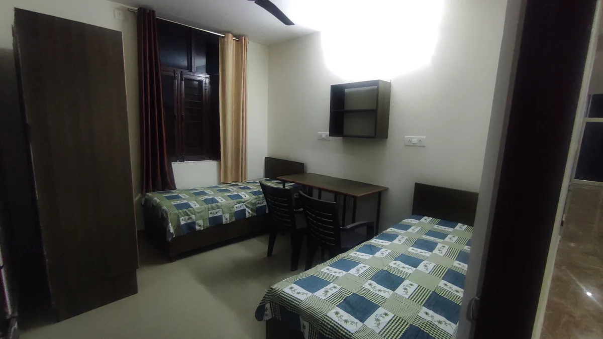 Private single room with comfortable bedding at Daksh Home boys hostel UPES