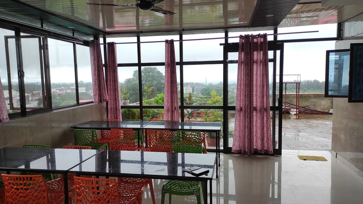 Outdoor dining terrace with garden at Daksh Home hostel near UPES Dehradun